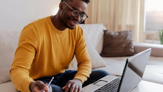 A student reviews college admissions results on his laptop