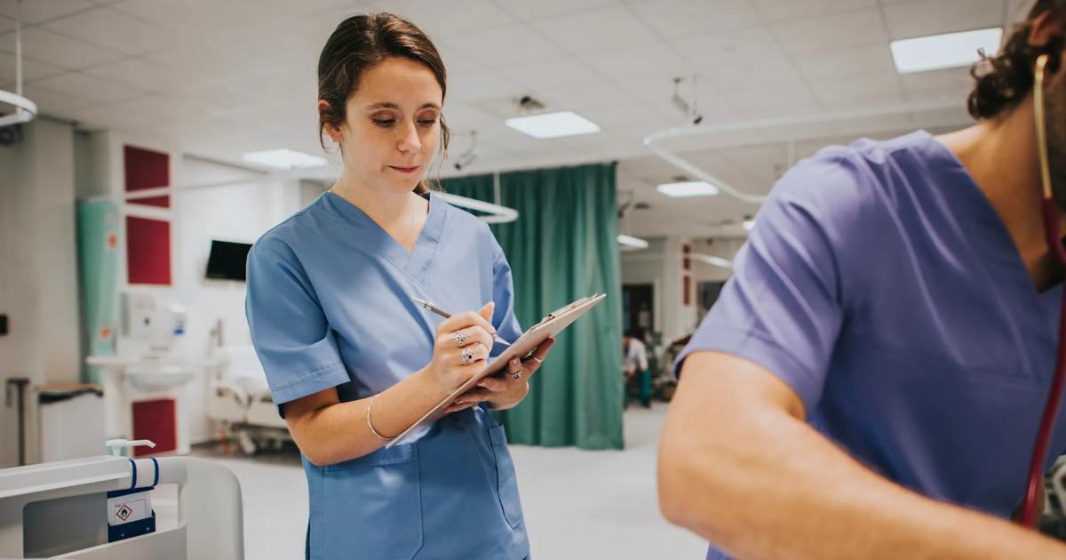 Young female nurse taking notes