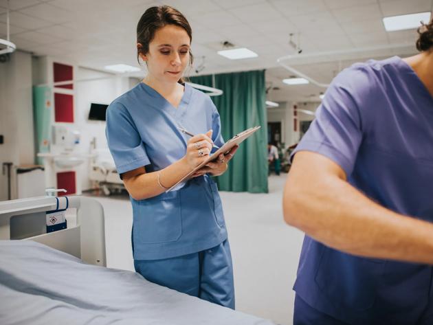 Young female nurse taking notes