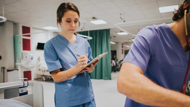 Young female nurse taking notes