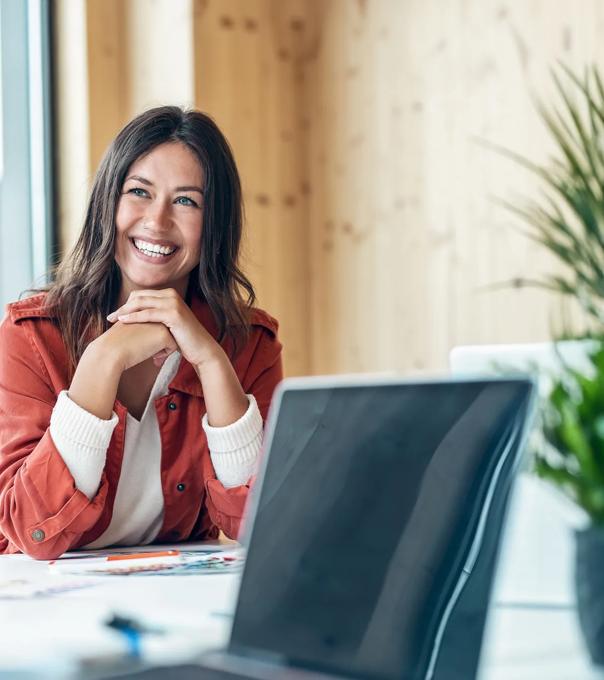 Smiling paralegal sits at a conference table in between working on briefs.