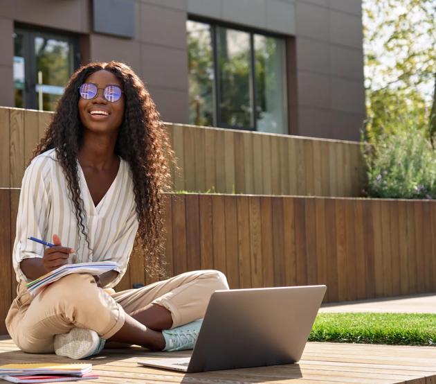 Happy_African_Woman_Student_Elearning_Using_Laptop