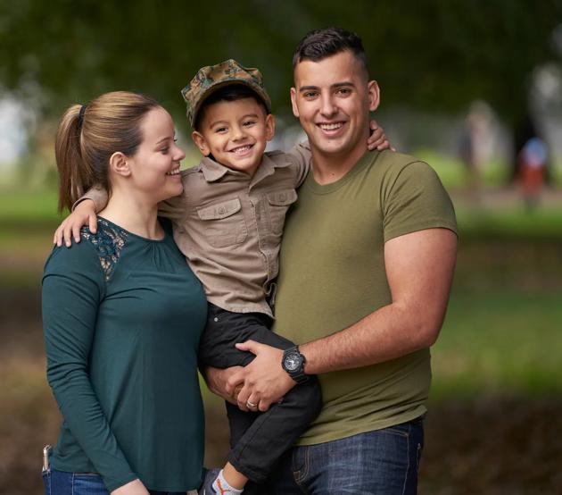 Smiling military family spending time together at the park.