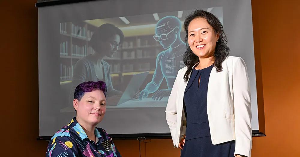 Dr. Jinhee Kim (standing) and PhD candidate Kay "Rita" Detrick