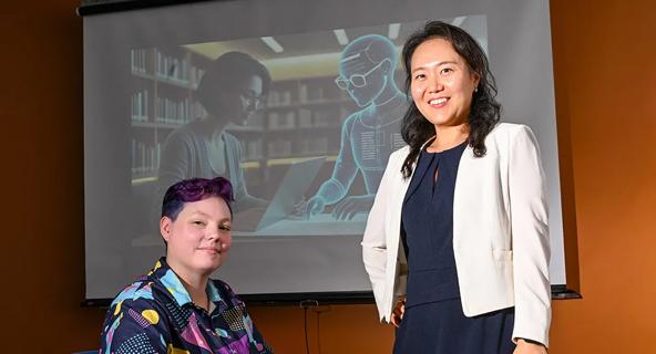 Dr. Jinhee Kim (standing) and PhD candidate Kay "Rita" Detrick