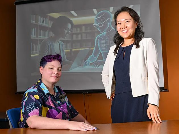 Dr. Jinhee Kim (standing) and PhD candidate Kay "Rita" Detrick