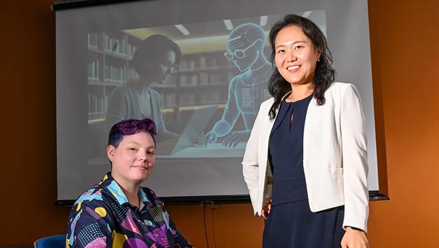 Dr. Jinhee Kim (standing) and PhD candidate Kay "Rita" Detrick