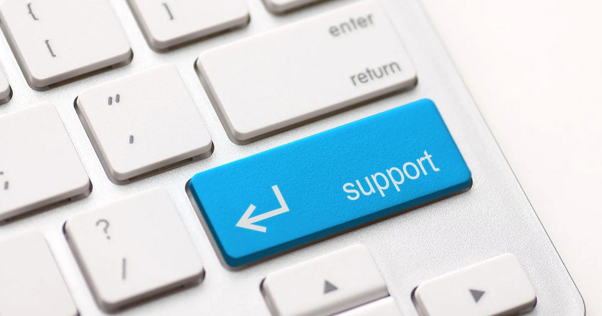 Close-up of a keyboard with a blue "support" key highlighted.