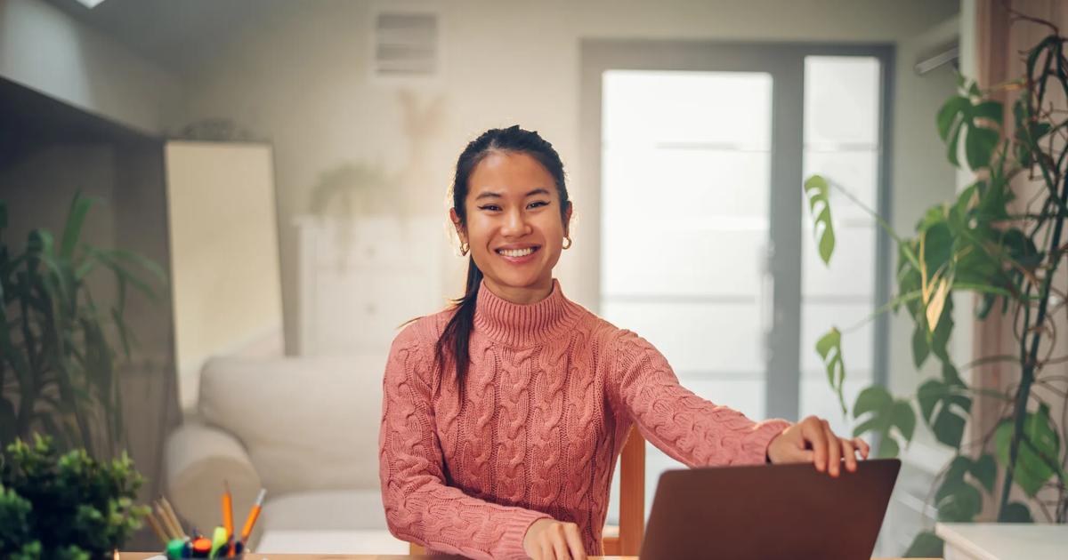 Portrait of a Vietnamese Asian woman using a laptop at home
