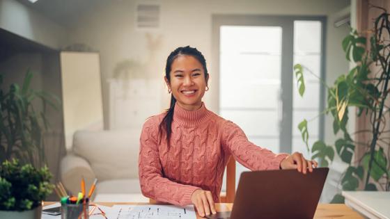 Portrait of a Vietnamese Asian woman using a laptop at home