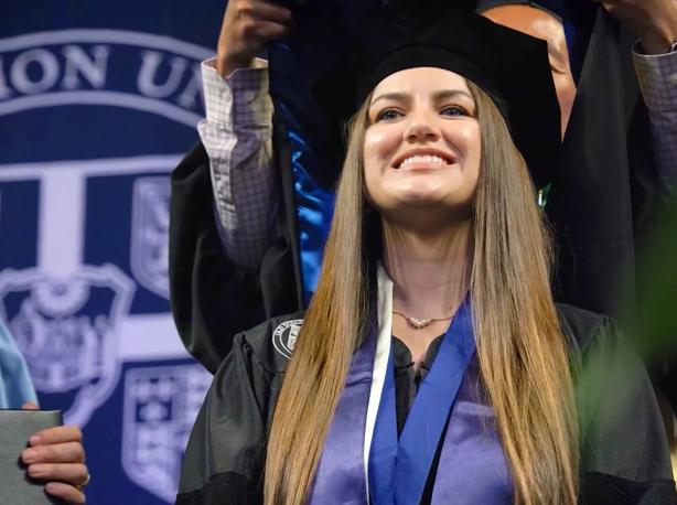 Ashlee Steeley is hooded at commencement as she receives her doctor of health sciences degree.