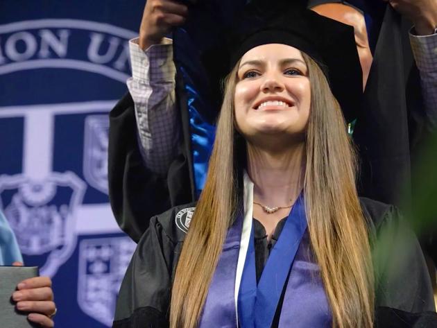 Ashlee Steeley is hooded at commencement as she receives her doctor of health sciences degree.