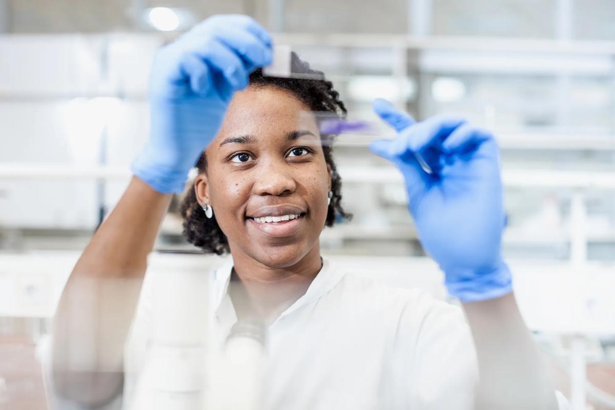 Young woman examining instruments in a medical laboratory.