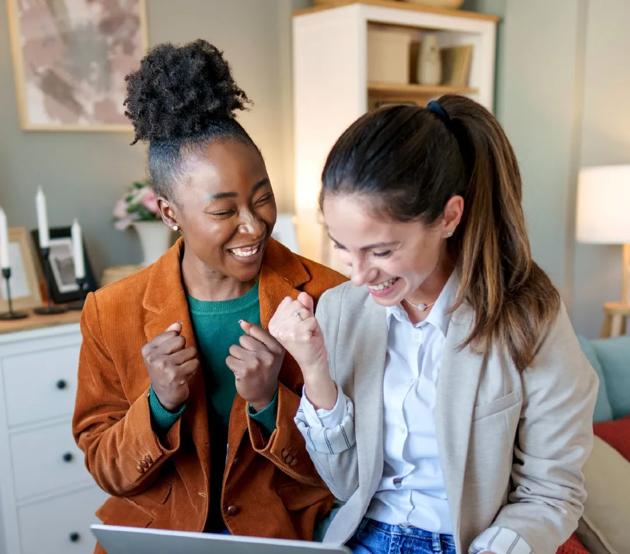 Two female friends get excited after being accepted to college