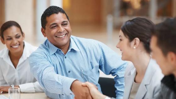 Business professionals shaking hands in agreement