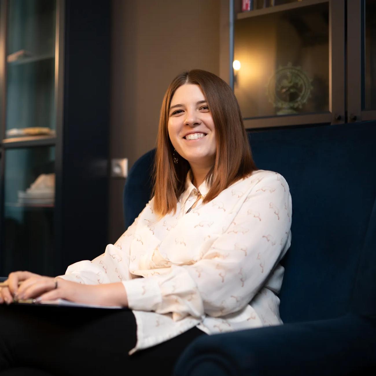 A seated female student leans back and smiles during a study break