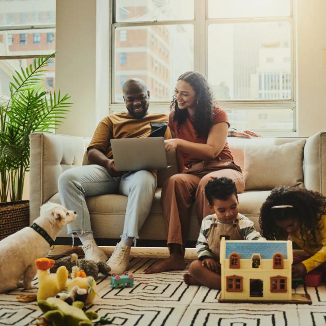 African American family explores ODUGlobal programs with a dog and children seated nearby.