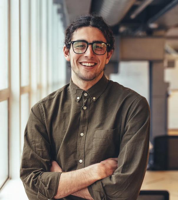 Happy_Businessman_Standing_in_Office