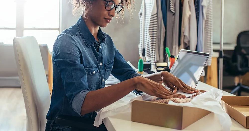Entrepreneur packing products for her small business.