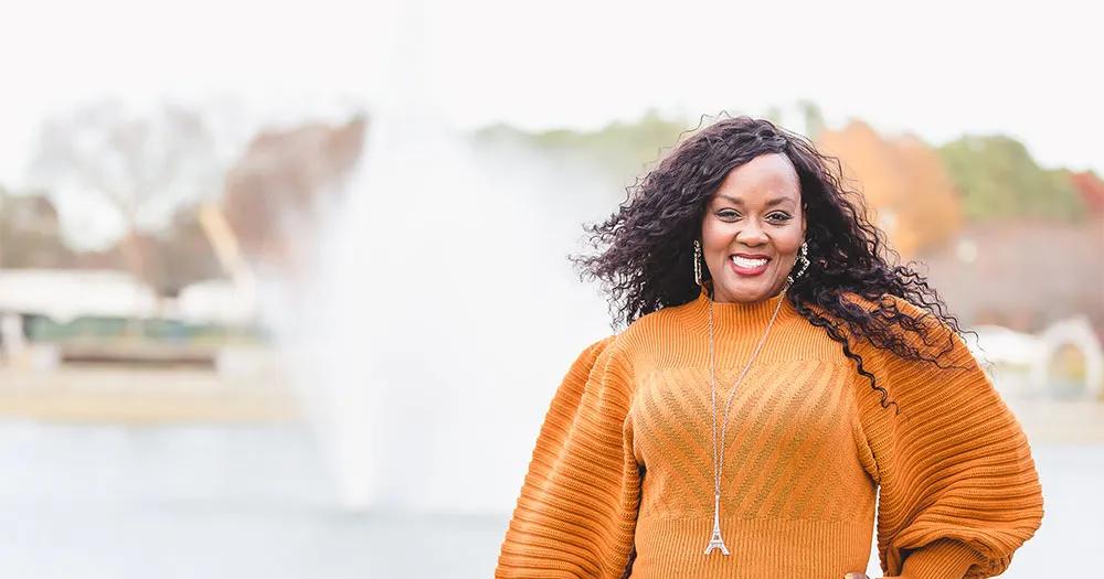 Dr. Narketta Sparkman-Key standing outdoors and smiling.