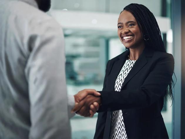 Person shaking hands with a client in a business meeting