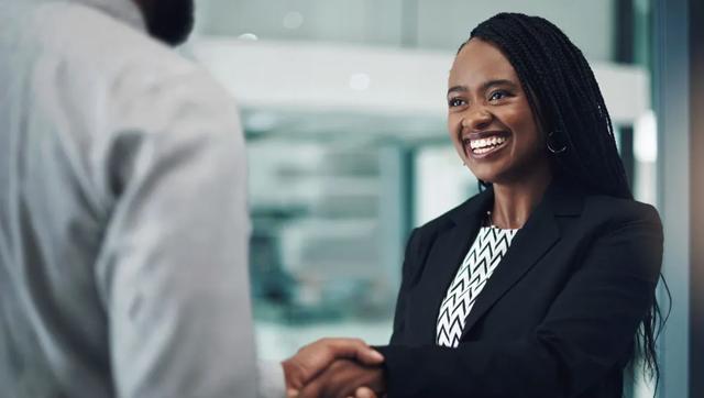 Person shaking hands with a client in a business meeting