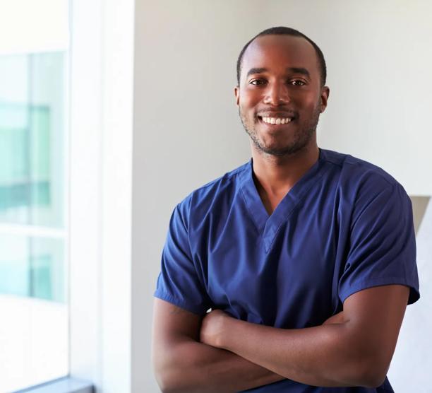 Portrait of a male nurse in scrubs smiling