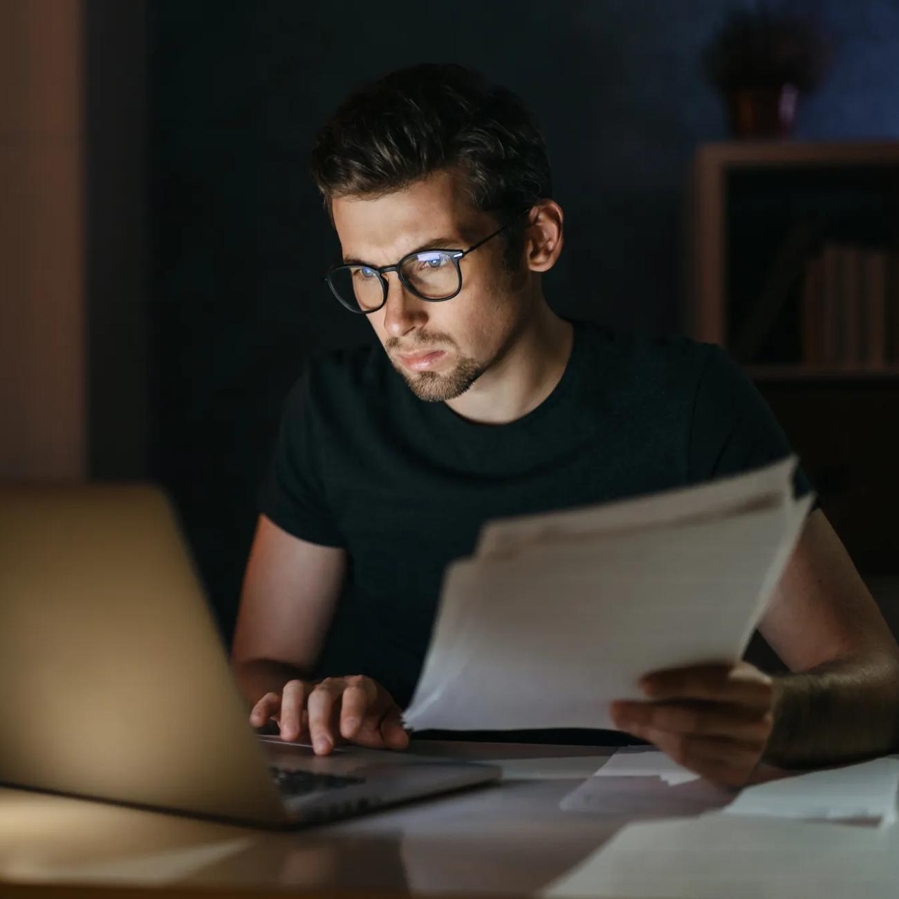 Young businessman working late at night from home