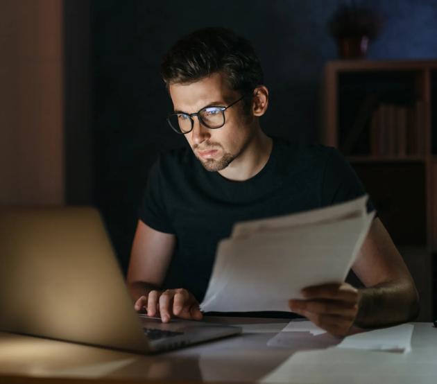 Young businessman working late at night from home