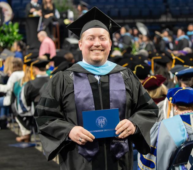 An ODUGlobal student smiles at commencement after graduating with his degree.