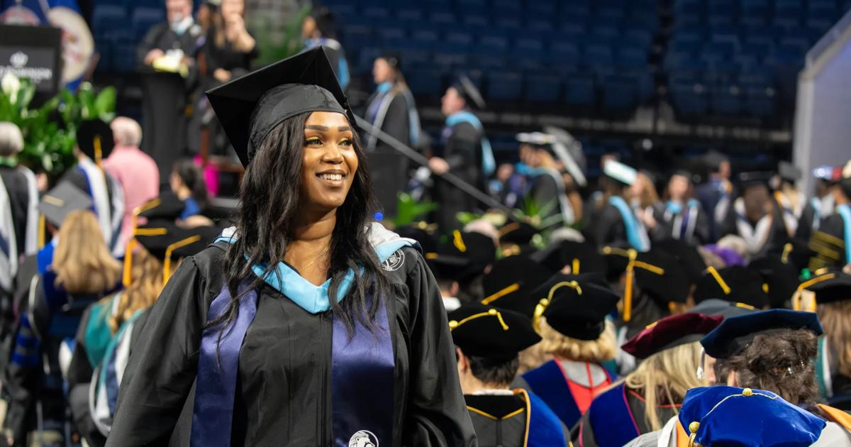 An ODUGlobal student proudly receives her degree during commencement.