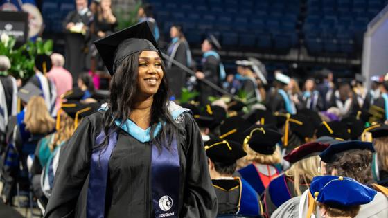 An ODUGlobal student proudly receives her degree during commencement.