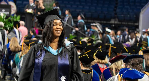 An ODUGlobal student proudly receives her degree during commencement.