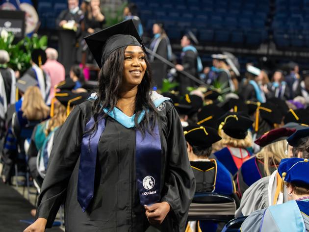 An ODUGlobal student proudly receives her degree during commencement.