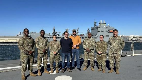 Nick Mann '26 stands with colleagues on deck of a U.S. Navy ship.