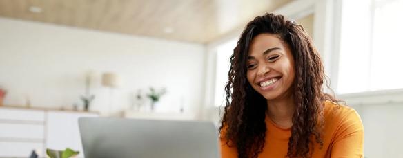 A student works on her laptop at a table