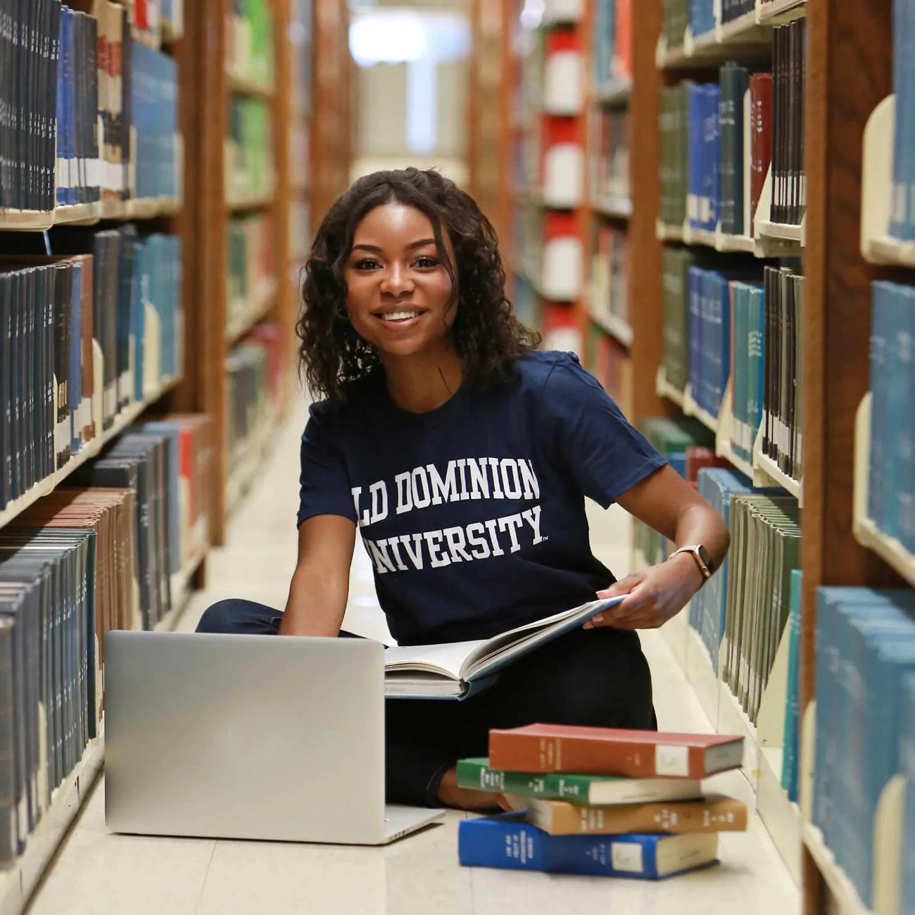 Smiling Old Dominion University student studying in library