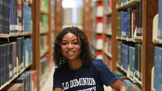 Smiling Old Dominion University student studying in library