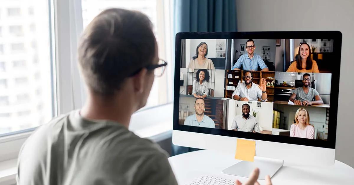 A man joins a webinar from his desktop computer