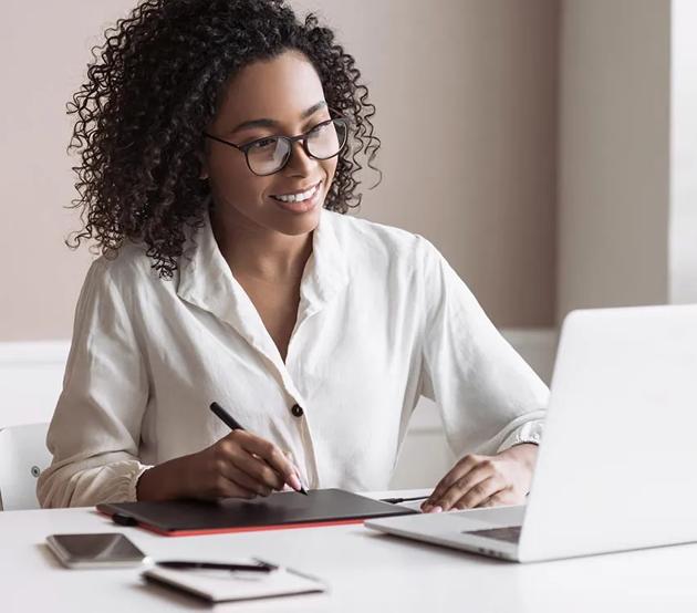 Cheerful student attending an online class at home.