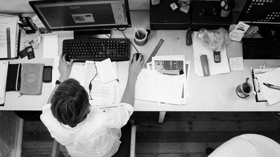 Overhead view of professional at desk with computer