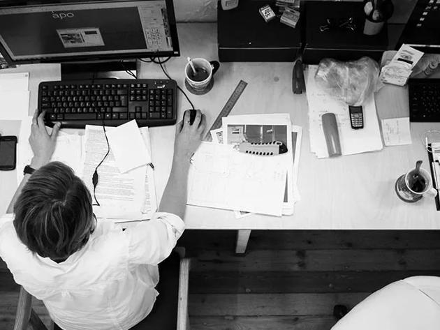Overhead view of professional at desk with computer