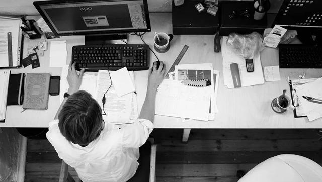 Overhead view of professional at desk with computer
