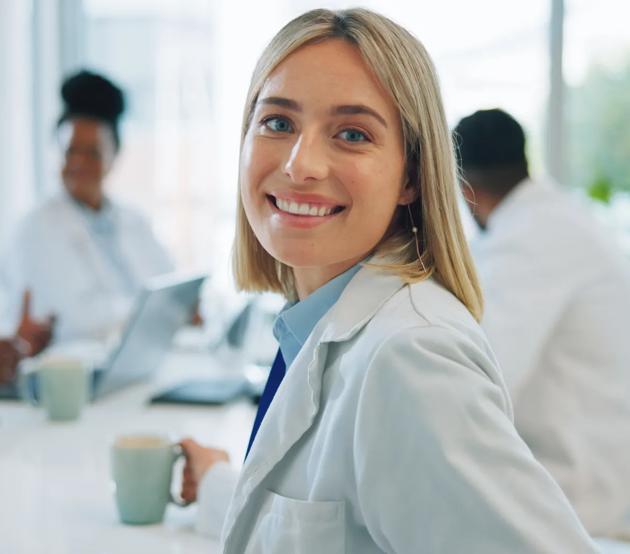 Portrait, woman and doctors in a meeting, smile and healthcare with planning, hospital and teamwork.