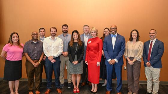 Graduating students from the 10th cohort of the Public Sector Leadership graduate certificate pose for a group photo with ODU and USFCC leaders.