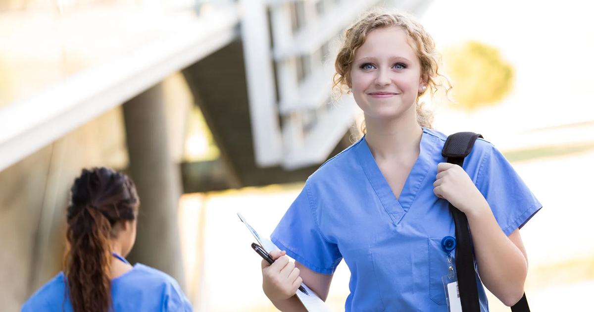 Healthcare worker in scrubs heading to work.