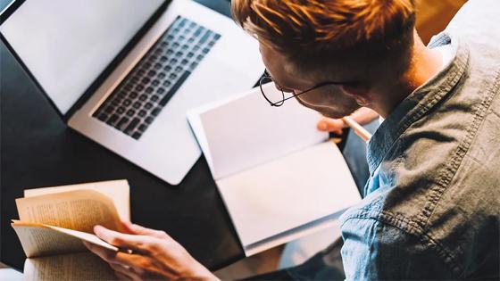 Person sitting at a computer getting organized for an online class