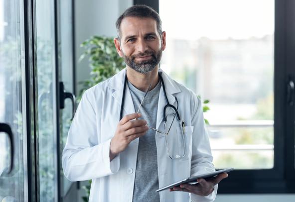 Medical Science doctor smiling in his medical office.