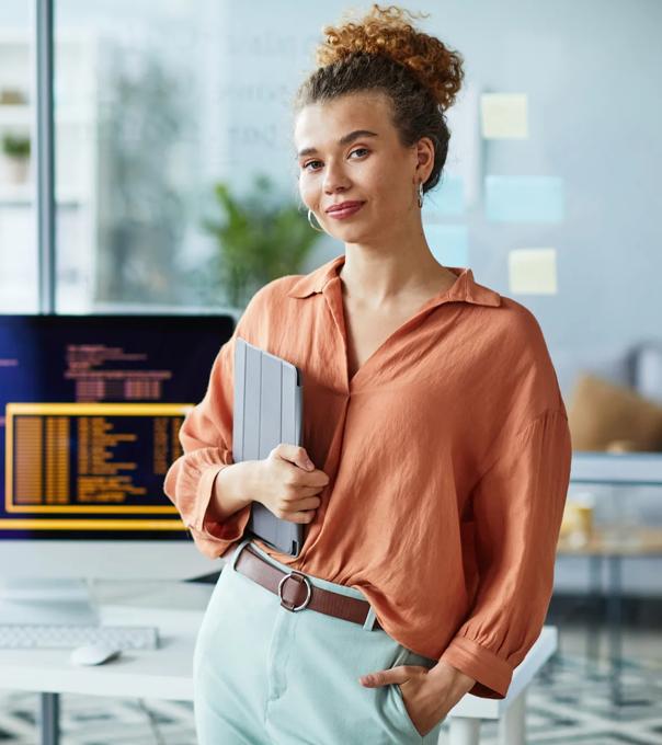 Programmer smiling in front of her computer