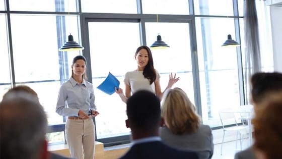 Workplace trainer talks to business professionals after learning occupational studies